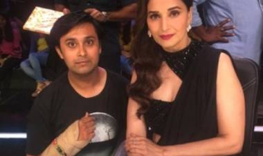 Madhuri Dixit Nene ties a rakhi to one of her fans