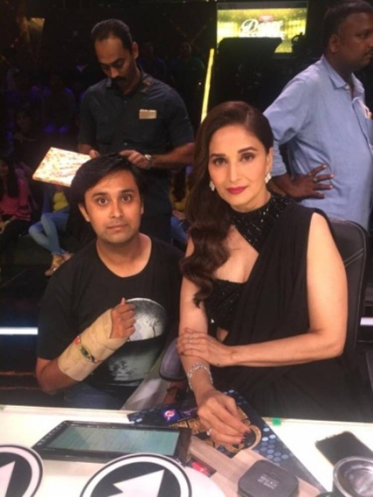 Madhuri Dixit Nene ties a rakhi to one of her fans